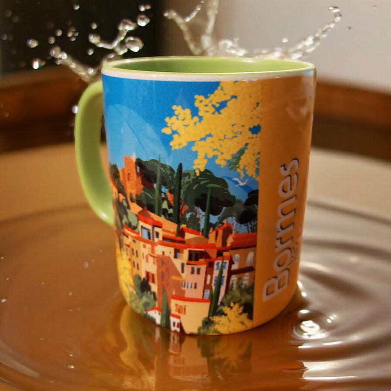 Mug illustré Bormes-les-Mimosas de Laurent Loiseau, affichant un design néo-rétro coloré qui reflète la beauté du village provençal, parfait comme mug cadeau noël.